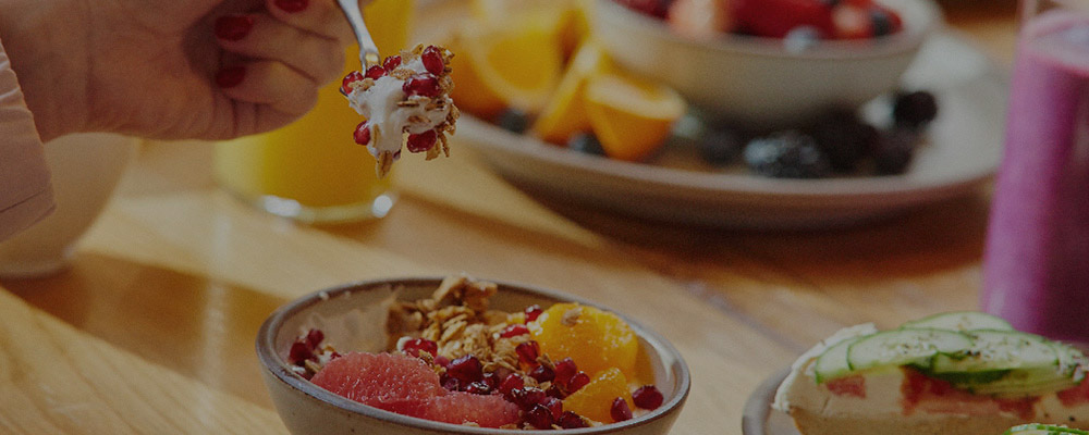 person eating yogurt and fruit