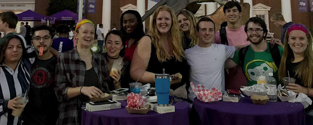 college students smiling in group shot at event